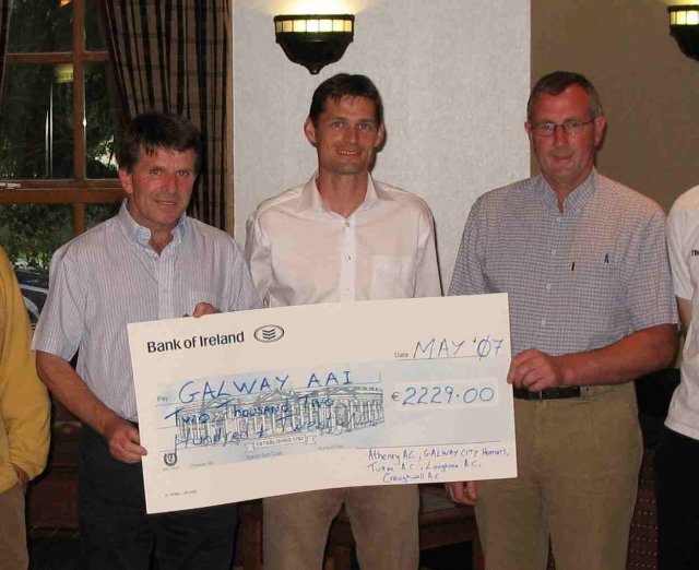 Galway AAI County Board officials accept a cheque for over Euro 2000.00 raised from this year's Galway 5km series