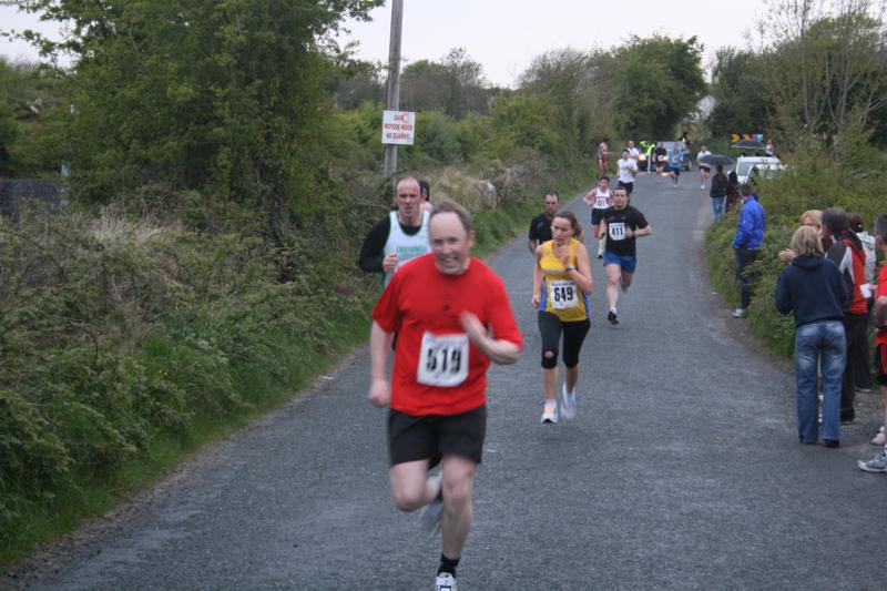 Swinford 8k Women's race winner Regina Casey (GCH) on her way to the line ahead of Owen Murphy